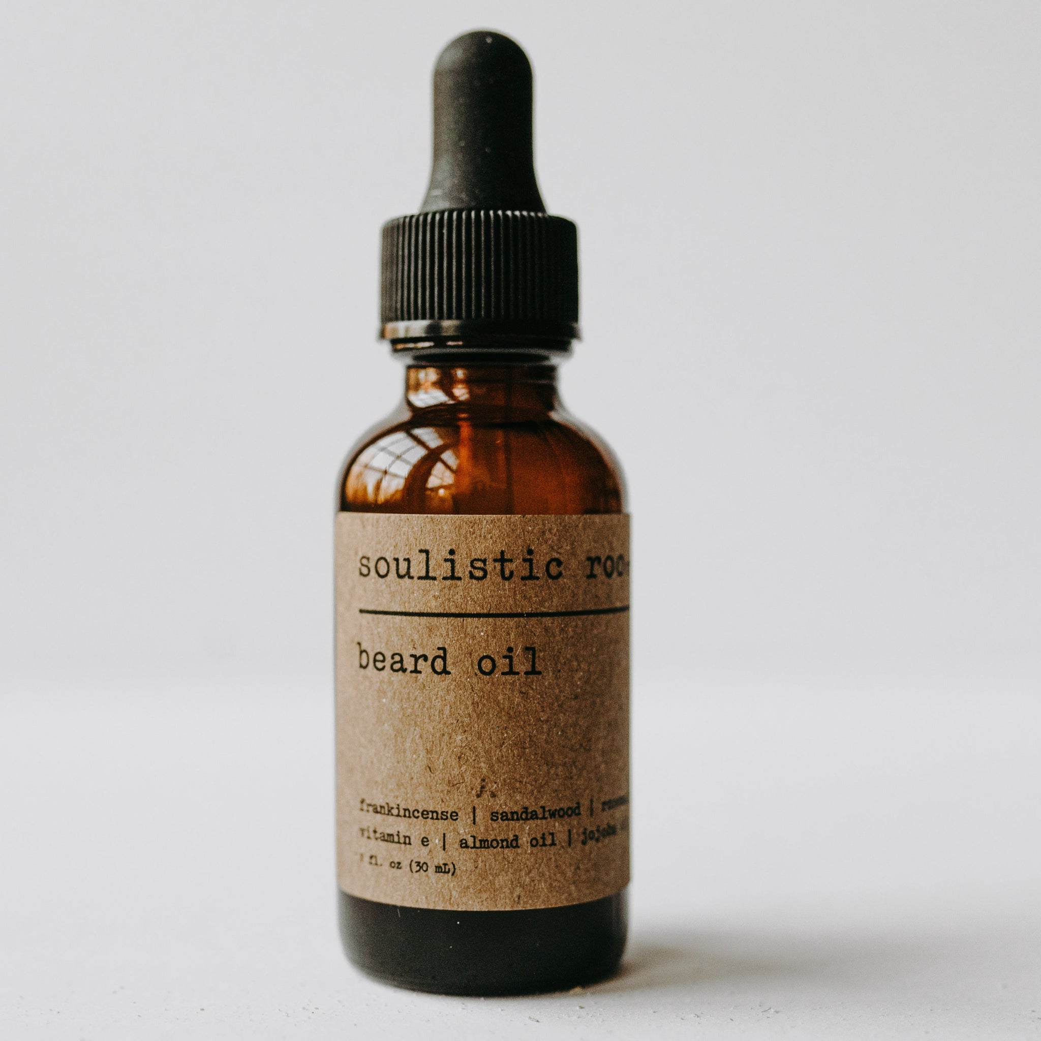 Beard oil in an amber bottle with glass dropper